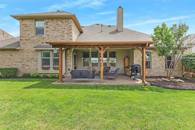 back of house with a patio, a yard, outdoor lounge area, roof with shingles, and a chimney