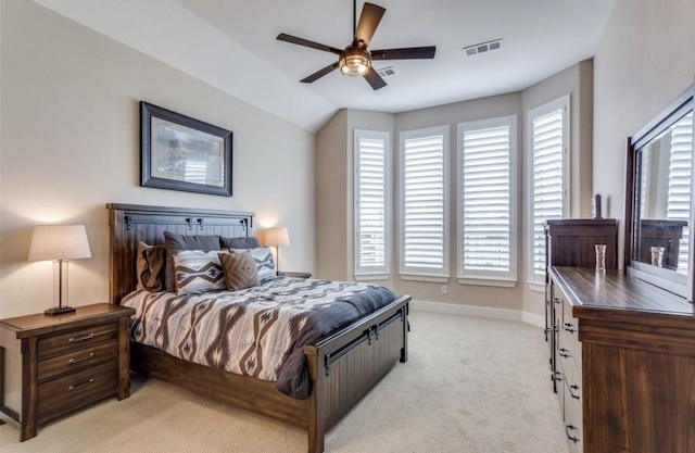 bedroom featuring light carpet, a ceiling fan, baseboards, lofted ceiling, and visible vents