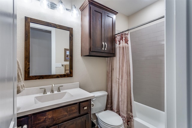 bathroom featuring toilet, a textured wall, shower / tub combo, and vanity
