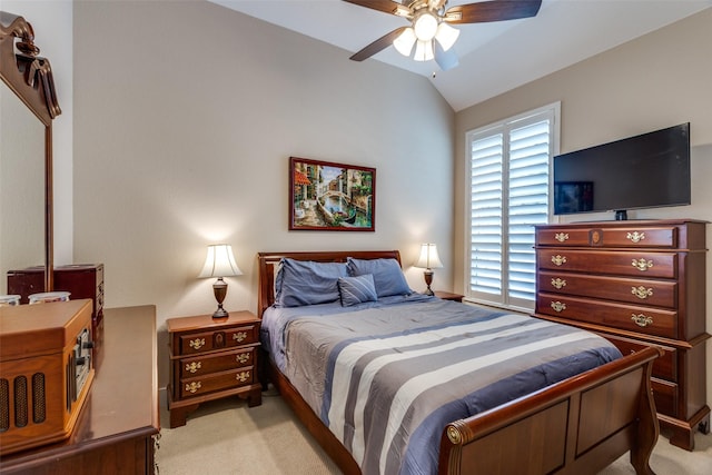 bedroom with a ceiling fan, vaulted ceiling, and light colored carpet