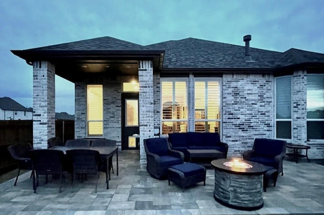view of patio with an outdoor living space with a fire pit