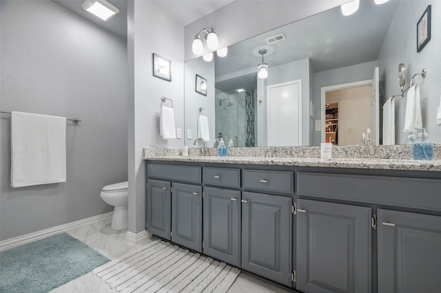 1600 Skyview Dr, Irving, TX 75060 - bathroom featuring a sink, a walk in closet, double vanity, baseboards, and a stall shower