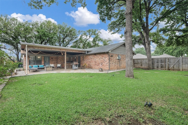 1600 Skyview Dr, Irving, TX 75060 - rear view of property featuring a fenced backyard, an outdoor living space, brick siding, a patio area, and a lawn