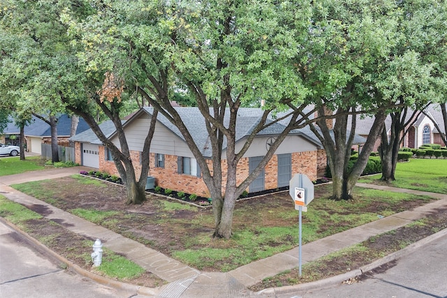 1600 Skyview Dr, Irving, TX 75060 - view of front facade with brick siding, a front lawn, an attached garage, and concrete driveway