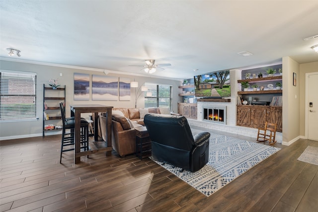 1600 Skyview Dr, Irving, TX 75060 - living area with a brick fireplace, dark wood-style flooring, baseboards, and ceiling fan