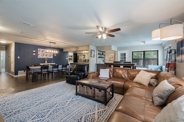 1600 Skyview Dr, Irving, TX 75060 - living area with baseboards, ceiling fan, wood finished floors, and visible vents