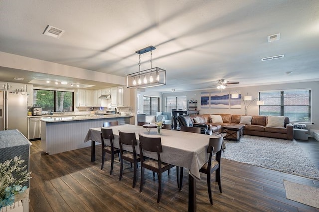 1600 Skyview Dr, Irving, TX 75060 - dining room featuring a ceiling fan, visible vents, a wealth of natural light, and dark wood finished floors