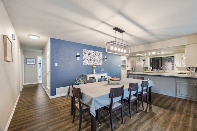 1600 Skyview Dr, Irving, TX 75060 - dining space featuring baseboards, dark wood-style floors, and visible vents