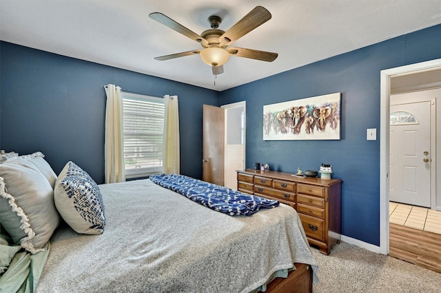 bedroom with baseboards, carpet, and a ceiling fan