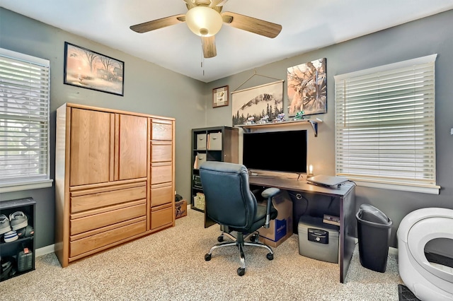 office with carpet, ceiling fan, and a healthy amount of sunlight