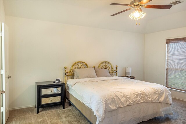 bedroom featuring carpet floors, baseboards, visible vents, and multiple windows