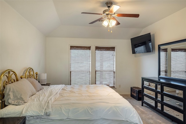 carpeted bedroom featuring a ceiling fan, lofted ceiling, and multiple windows