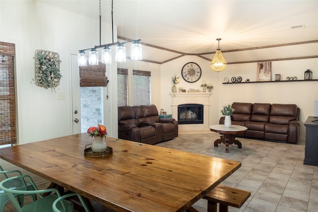 dining area featuring visible vents, light tile patterned flooring, and a fireplace