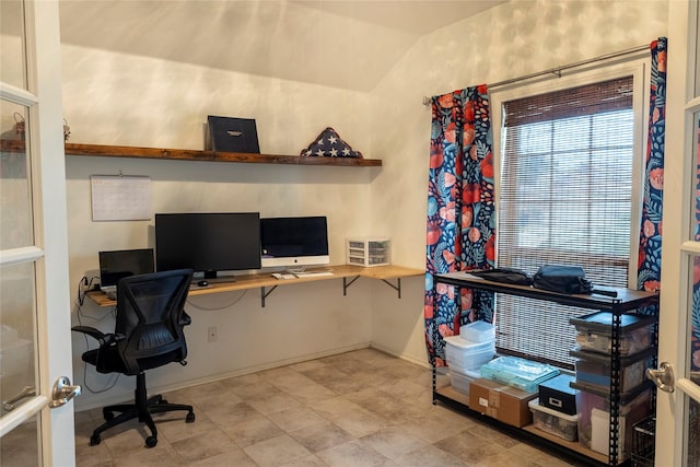 home office with baseboards and vaulted ceiling