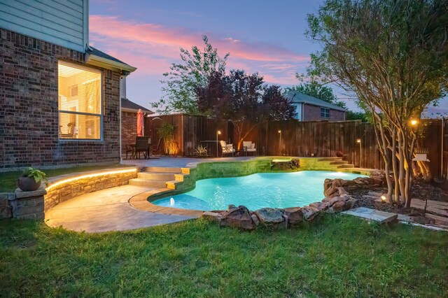 view of pool featuring a fenced backyard, a fenced in pool, a yard, and a patio area