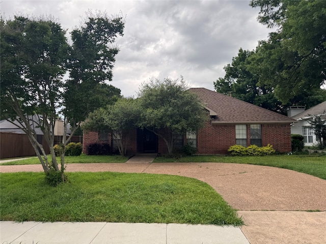 view of front of home with a front yard and brick siding