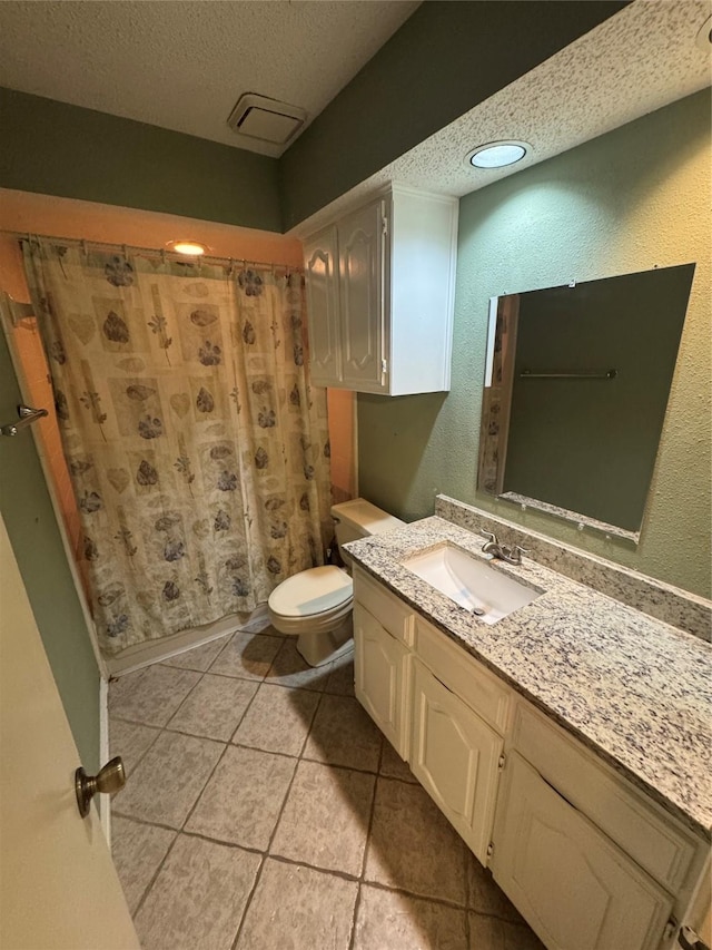 bathroom featuring toilet, a textured ceiling, curtained shower, and tile patterned flooring