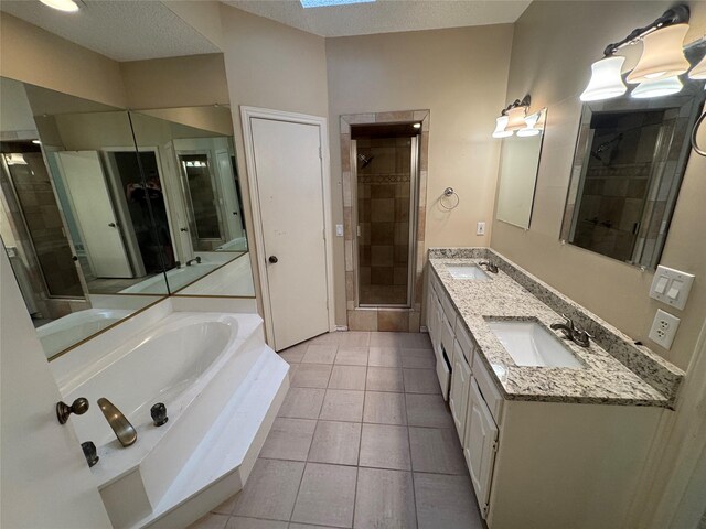 bathroom featuring a sink, tile patterned floors, a shower stall, and a bath