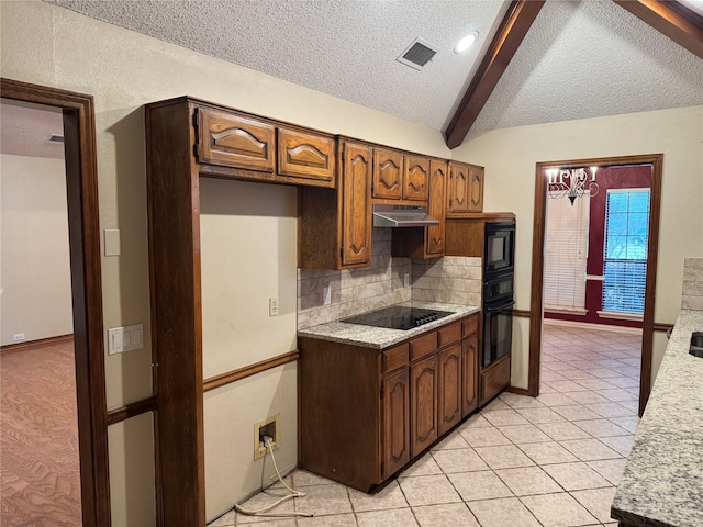 kitchen with light countertops, a textured ceiling, backsplash, under cabinet range hood, and black appliances