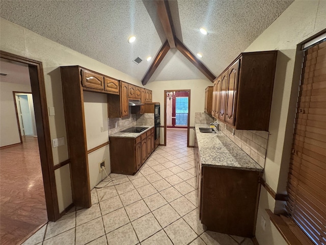 kitchen featuring a textured ceiling, tasteful backsplash, a sink, light countertops, and lofted ceiling with beams