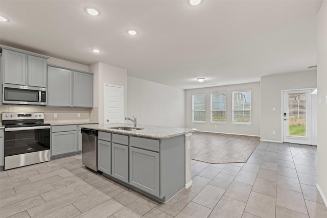 3819 Elkhorn Ln, Forney, TX 75126 - kitchen with appliances with stainless steel finishes, gray cabinetry, a sink, recessed lighting, and open floor plan