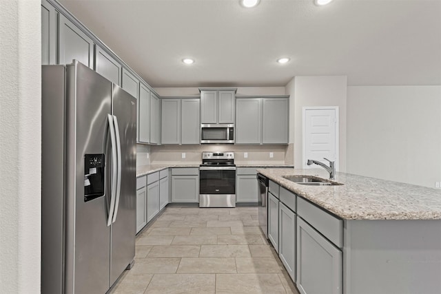 3819 Elkhorn Ln, Forney, TX 75126 - kitchen with appliances with stainless steel finishes, gray cabinetry, a sink, recessed lighting, and light stone counters