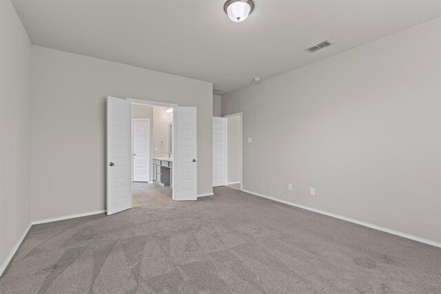 3819 Elkhorn Ln, Forney, TX 75126 - unfurnished bedroom featuring carpet, baseboards, and connected bathroom