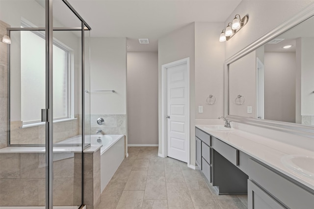 3819 Elkhorn Ln, Forney, TX 75126 - bathroom with double vanity, a bath, a shower stall, and baseboards