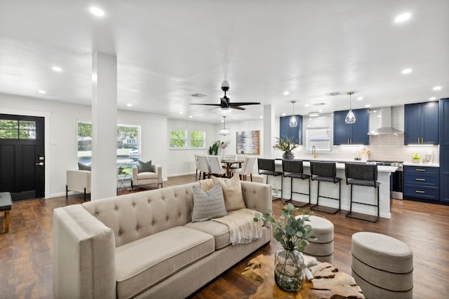 living room with dark wood-type flooring, recessed lighting, and a ceiling fan