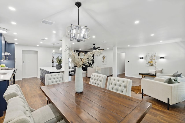 dining room with recessed lighting, ceiling fan with notable chandelier, dark wood-style flooring, and visible vents