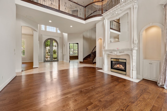 5404 Miramar Ln, Colleyville, TX 76034 - unfurnished living room with a high ceiling, wood finished floors, a high end fireplace, stairway, and baseboards