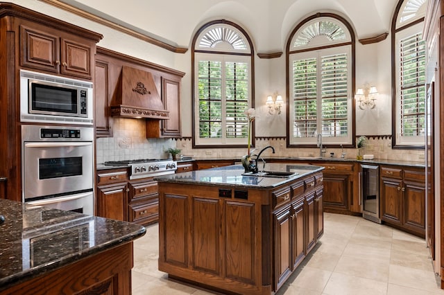 5404 Miramar Ln, Colleyville, TX 76034 - kitchen with beverage cooler, a sink, stainless steel appliances, dark stone countertops, and ornamental molding