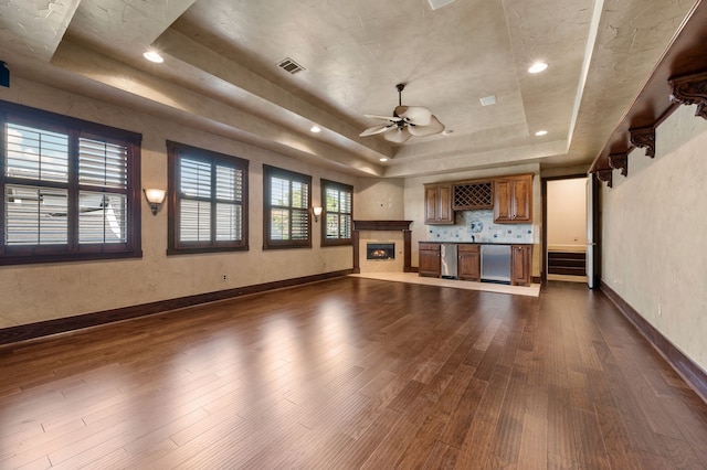 5404 Miramar Ln, Colleyville, TX 76034 - unfurnished living room with a raised ceiling, dark wood finished floors, ceiling fan, baseboards, and recessed lighting