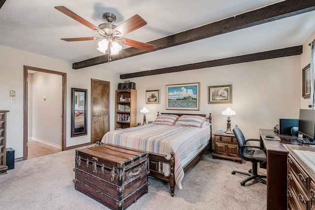 bedroom with light colored carpet, a ceiling fan, baseboards, and beam ceiling