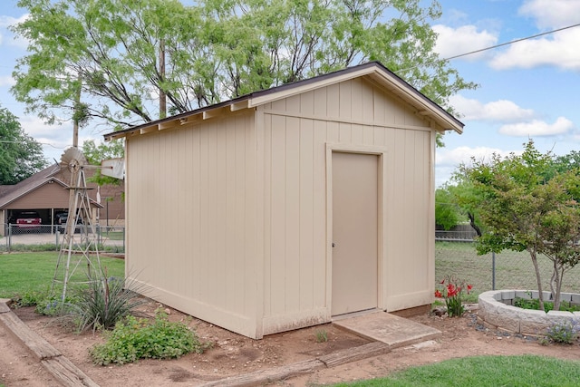 view of shed featuring fence