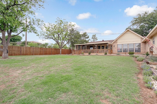 view of yard with fence and covered porch