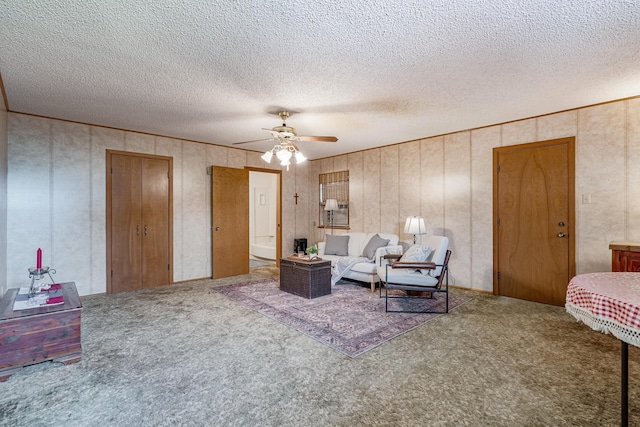 living room featuring carpet floors, a textured ceiling, and ceiling fan