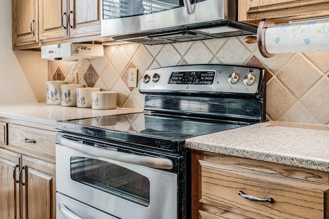kitchen with tasteful backsplash and stainless steel appliances