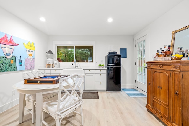 kitchen with freestanding refrigerator, light countertops, plenty of natural light, and light wood-type flooring