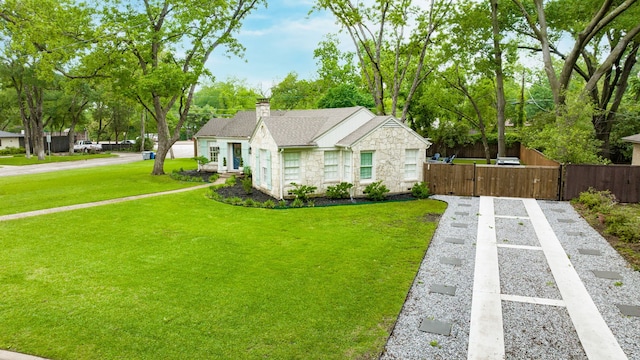 bungalow with a front lawn, fence, stone siding, a chimney, and a gate