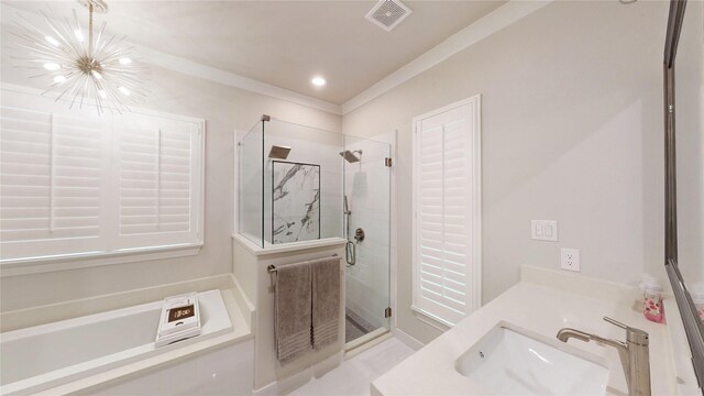 bathroom with visible vents, a garden tub, double vanity, a sink, and a stall shower