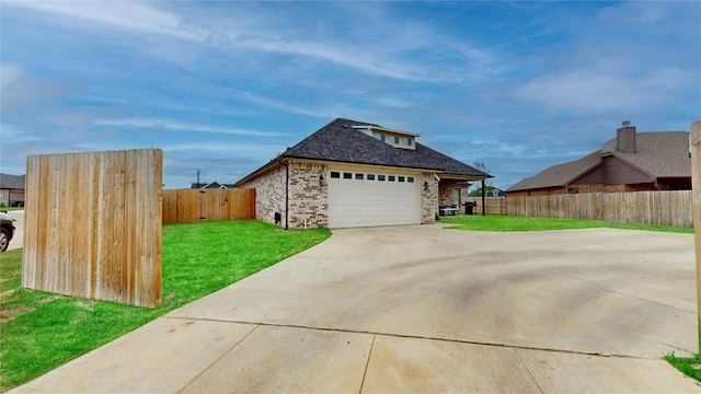 view of side of property featuring a lawn, brick siding, fence, and concrete driveway