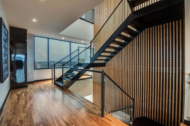 3111 Welborn St Unit 1703, Dallas, TX 75219 - stairway with baseboards, recessed lighting, and wood finished floors