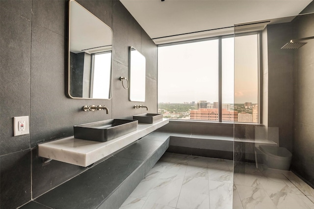 3111 Welborn St Unit 1703, Dallas, TX 75219 - bathroom featuring a view of city, toilet, a sink, and marble finish floor