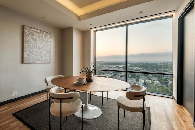 3111 Welborn St Unit 1703, Dallas, TX 75219 - dining area with baseboards, floor to ceiling windows, and wood finished floors