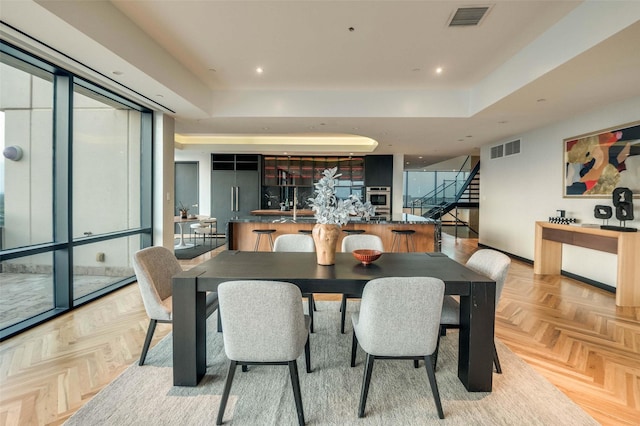 3111 Welborn St Unit 1703, Dallas, TX 75219 - dining room featuring visible vents, a raised ceiling, stairs, and recessed lighting