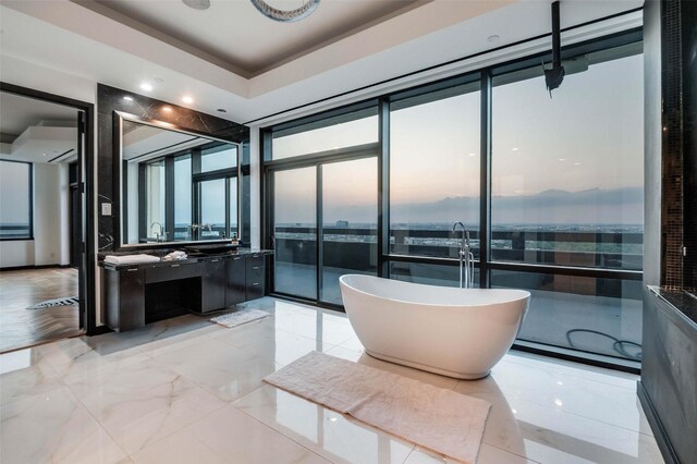 3111 Welborn St Unit 1703, Dallas, TX 75219 - full bathroom featuring expansive windows, a freestanding bath, and vanity