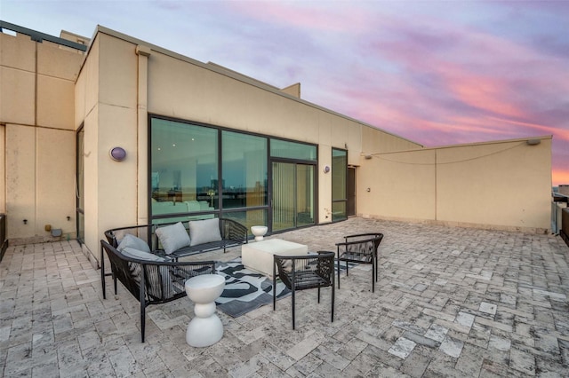 3111 Welborn St Unit 1703, Dallas, TX 75219 - patio terrace at dusk featuring outdoor lounge area