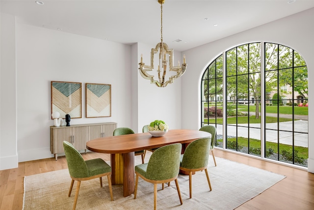 dining room featuring recessed lighting, baseboards, a chandelier, and light wood-style flooring