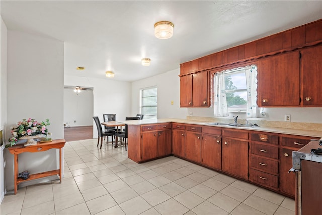 1733 Ransom Ter, Fort Worth, TX 76112 - kitchen with ceiling fan, electric range oven, a sink, light countertops, and a peninsula